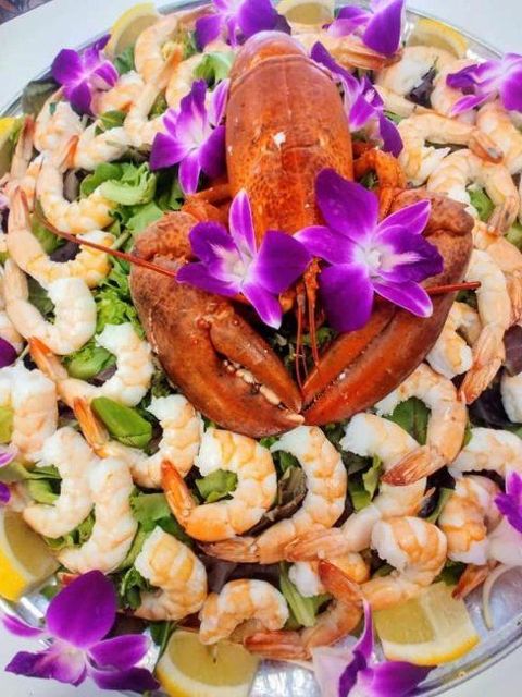 Shrimp cocktail platter with lobster and orchids